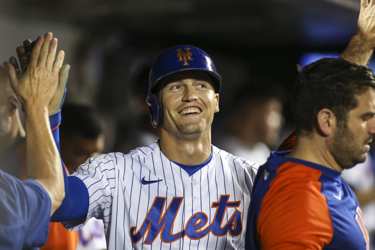 Mets outfielder Brandon Nimmo celebrates in the dugout. He could help solve the SF Giants defensive woes.